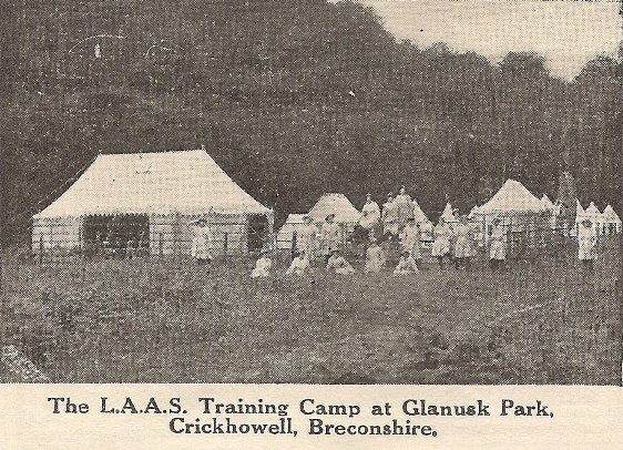 ‘This camp was opened on June 22nd, 1918, for the purpose of training Land Army recruits on the surrounding farms. It is beautifully situated on the banks of the River Usk. The site was given by Lord Glanusk, who has also been most generous in supplying everything that could add to the comfort of the Camp; building wooden huts for kitchen, store-rooms and wash-houses; and having water laid on and a boiler and camp oven built. All these items have been greatly appreciated by the Staff and Trainees. There are 18 tents in all, 15 sleeping tents, a mess tent, outfit store tent, and recreation tent with piano, which is a most popular addition.’ (The Landswoman, October 1918, No. 8, Vol. 1.)
